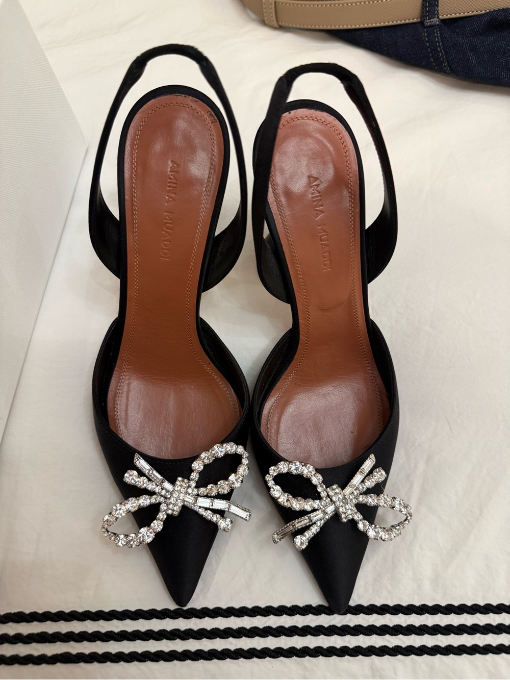 Amina Muaddi Black Satin Slingback Pumps with Crystal Bow